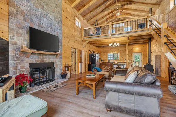a living room with furniture a flat screen tv and a fireplace