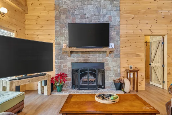 a living room with a fireplace a flat screen tv and a fireplace