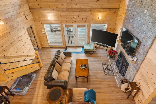 a view of a livingroom with furniture wooden floor and windows