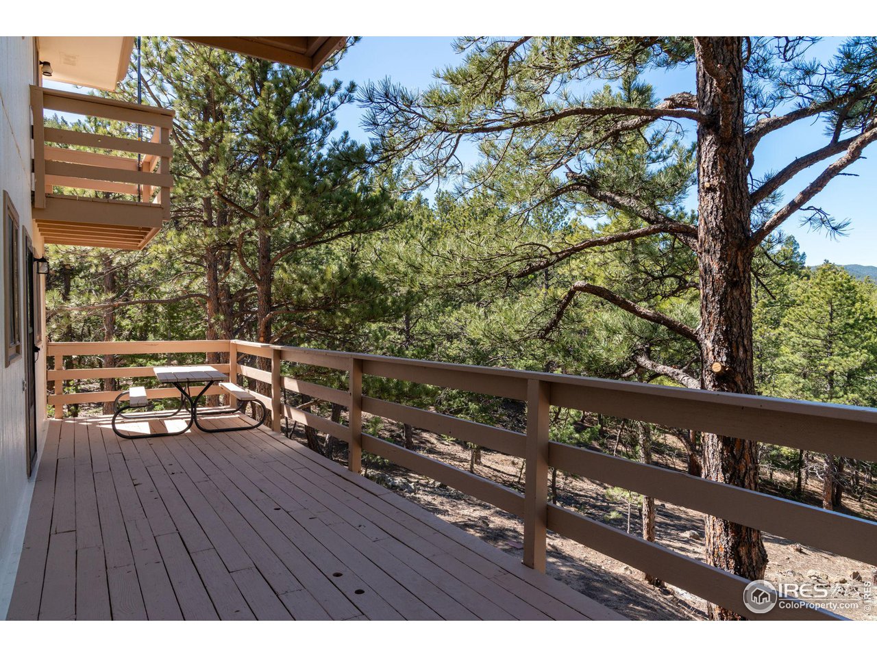 757 Peakview Road Boulder, CO 80302 - Photo 25 of 34 a view of a balcony with wooden floor and bench