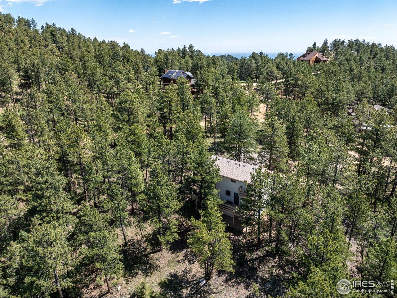 757 Peakview Road Boulder, CO 80302 - Photo 34 of 34 a view of a house with a lush green forest