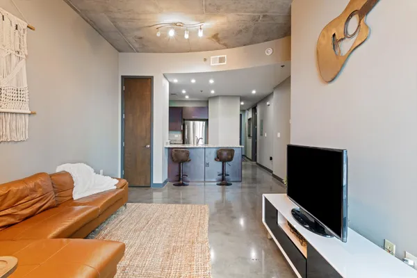 a living room with furniture and a flat screen tv