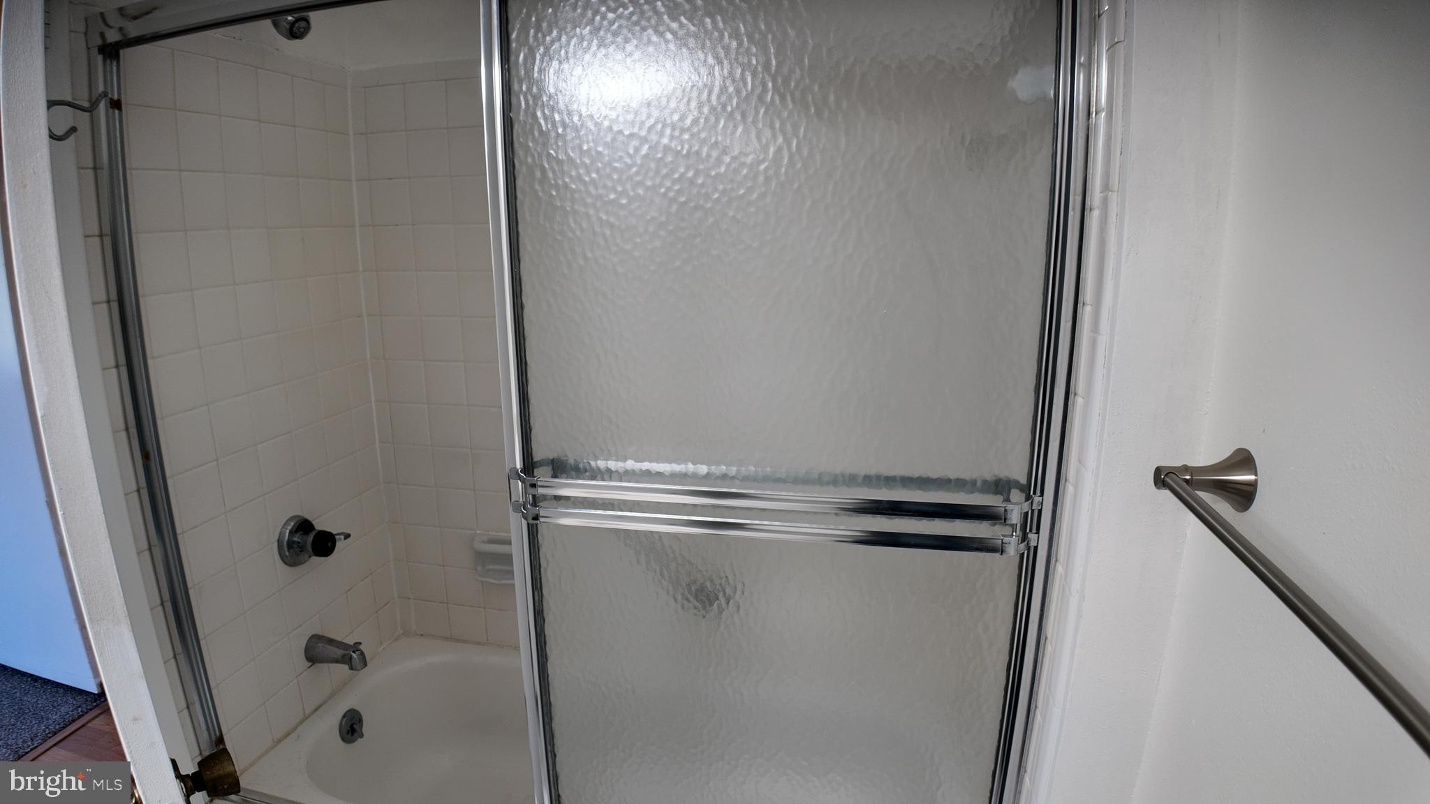 15311 Beaverbrook Court, Unit 903B Silver Spring, MD 20906 - Photo 25 of 36 a bathroom with a glass shower door