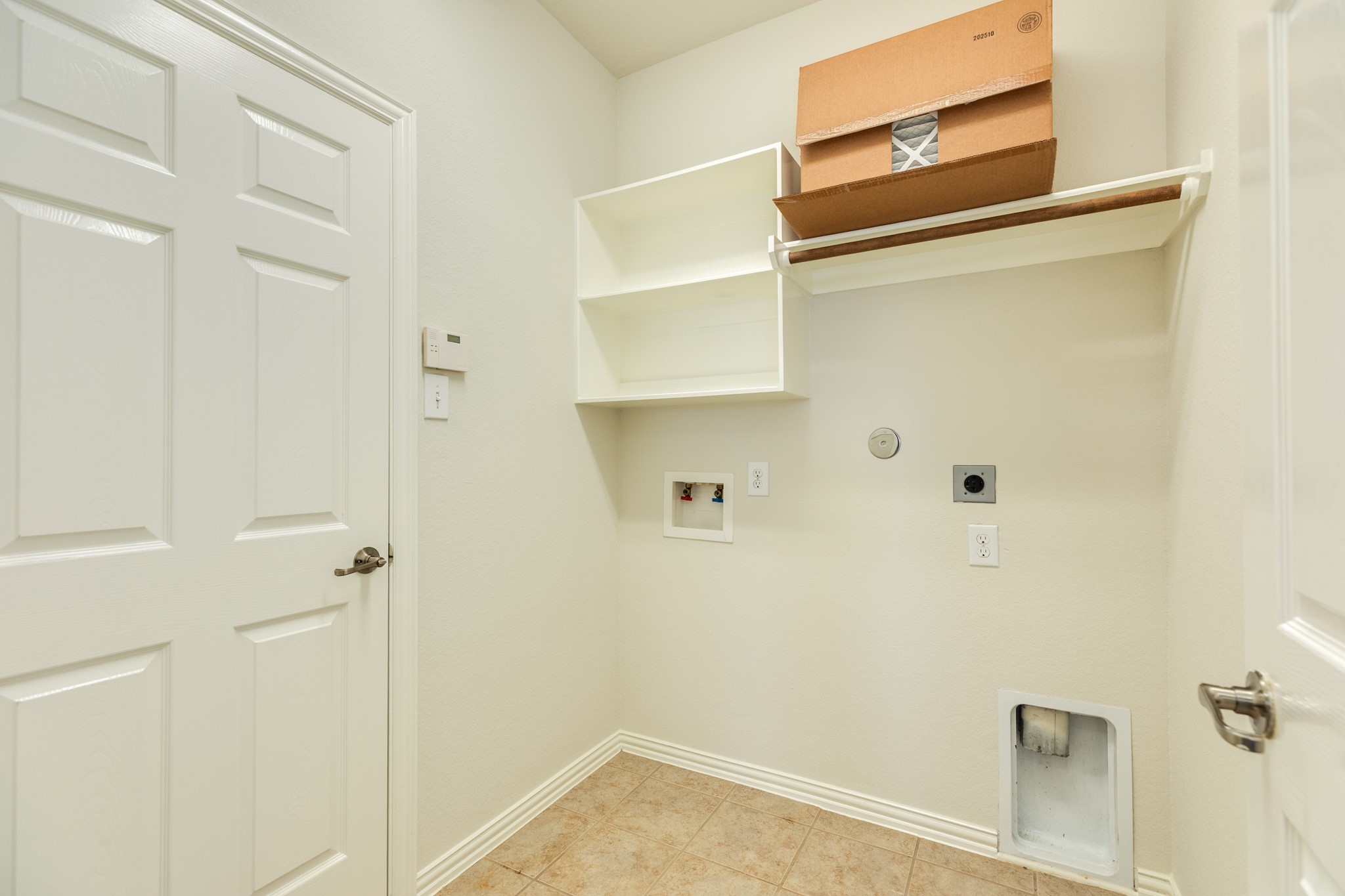 13417 Star Creek Lane Rosharon, TX 77583 - Photo 27 of 41 The laundry room includes storage, a clothes rack, and tile flooring.