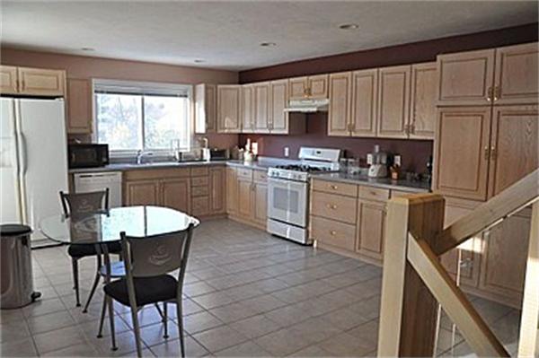 45 Half Crown Circle, Unit 45 Ashland, MA 01721 - Photo 12 of 19 a kitchen with a stove a sink a microwave and cabinets