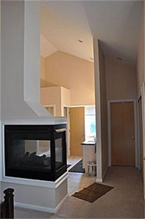 45 Half Crown Circle, Unit 45 Ashland, MA 01721 - Photo 9 of 19 a living room with a fireplace and a window
