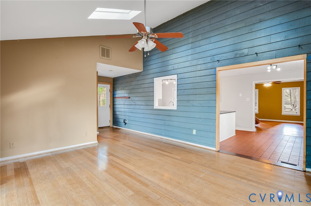 1140 Berryhill Road Henrico, VA 23231 - Photo 12 of 29 Empty room with wooden walls, ceiling fan, high va