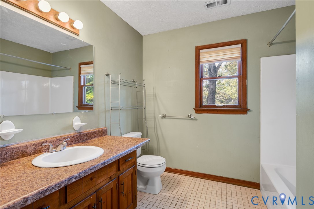 1140 Berryhill Road Henrico, VA 23231 - Photo 23 of 29 Bathroom with a textured ceiling, vanity, bathtub