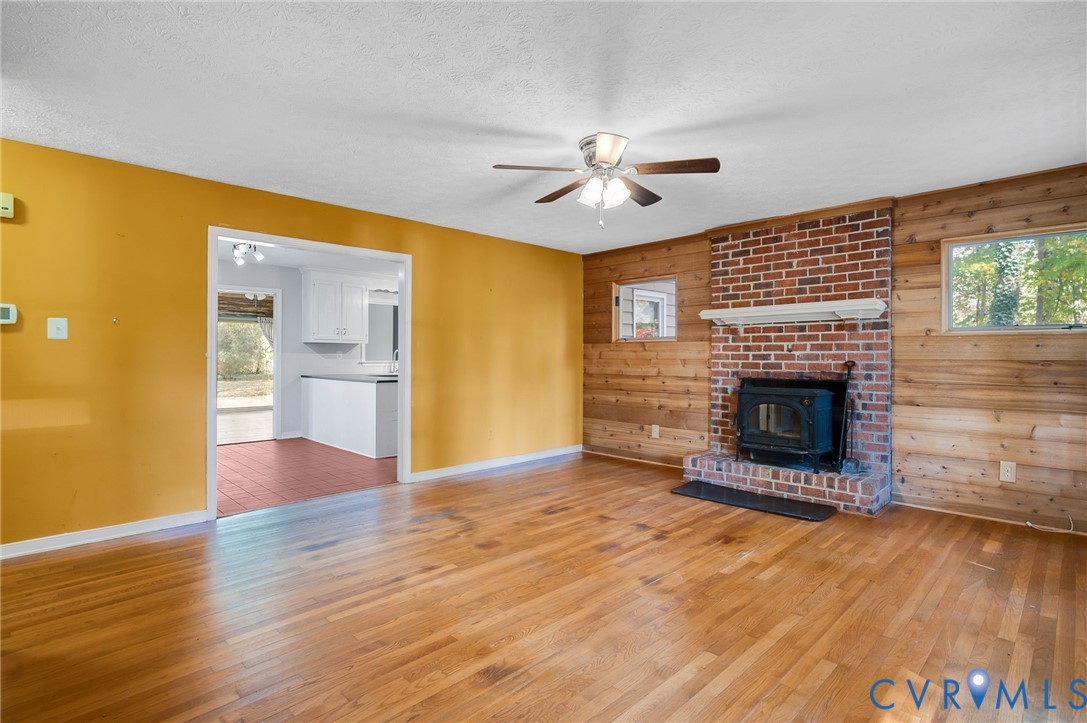 1140 Berryhill Road Henrico, VA 23231 - Photo 4 of 29 Unfurnished living room featuring wooden walls, pl