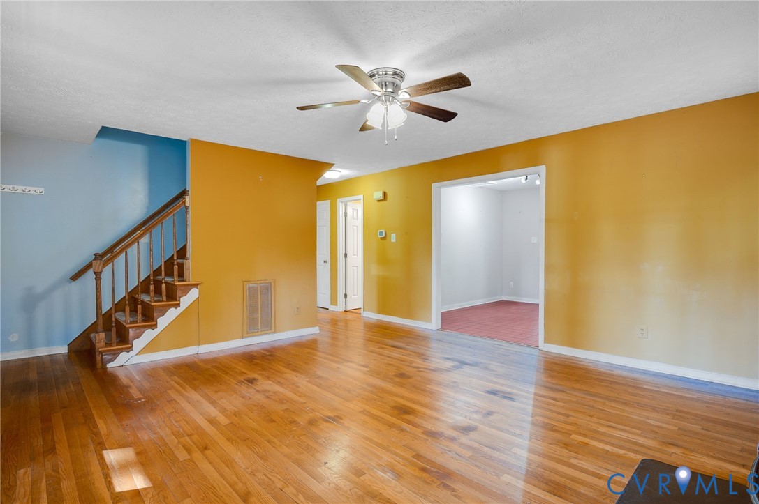 1140 Berryhill Road Henrico, VA 23231 - Photo 5 of 29 Unfurnished living room featuring stairs, light wo