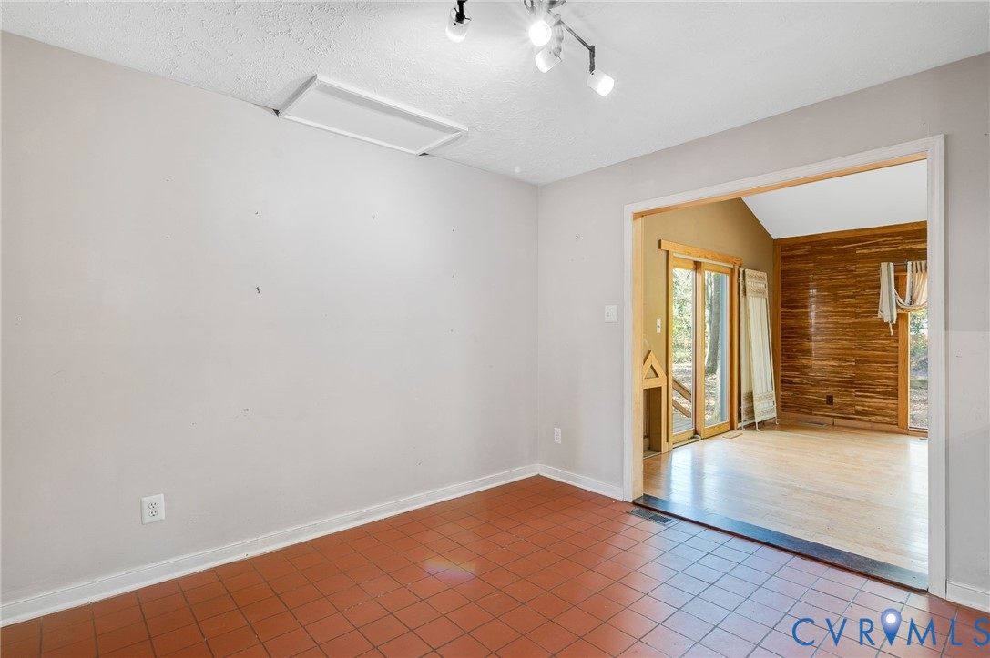 1140 Berryhill Road Henrico, VA 23231 - Photo 7 of 29 Spare room with tile patterned flooring, vaulted c