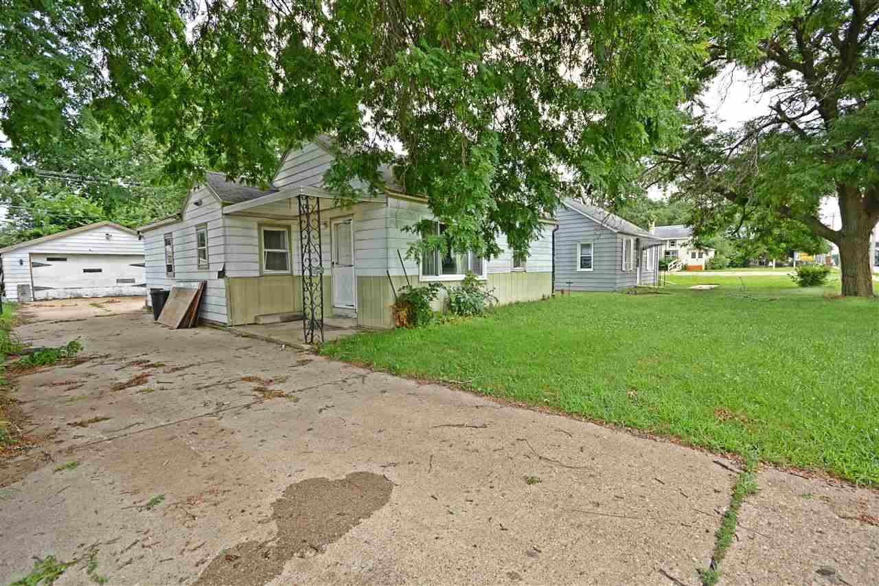 916 Windsor Road Loves Park, IL 61111 - Photo 1 of 14 a front view of a house with garden
