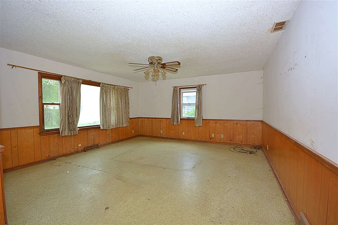 916 Windsor Road Loves Park, IL 61111 - Photo 4 of 14 a view of an empty room with a window