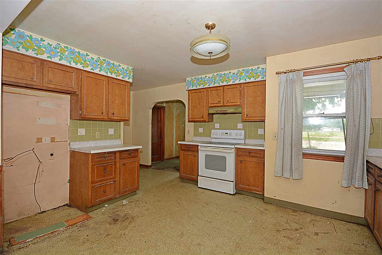 916 Windsor Road Loves Park, IL 61111 - Photo 7 of 14 a kitchen with sink a stove and cabinets