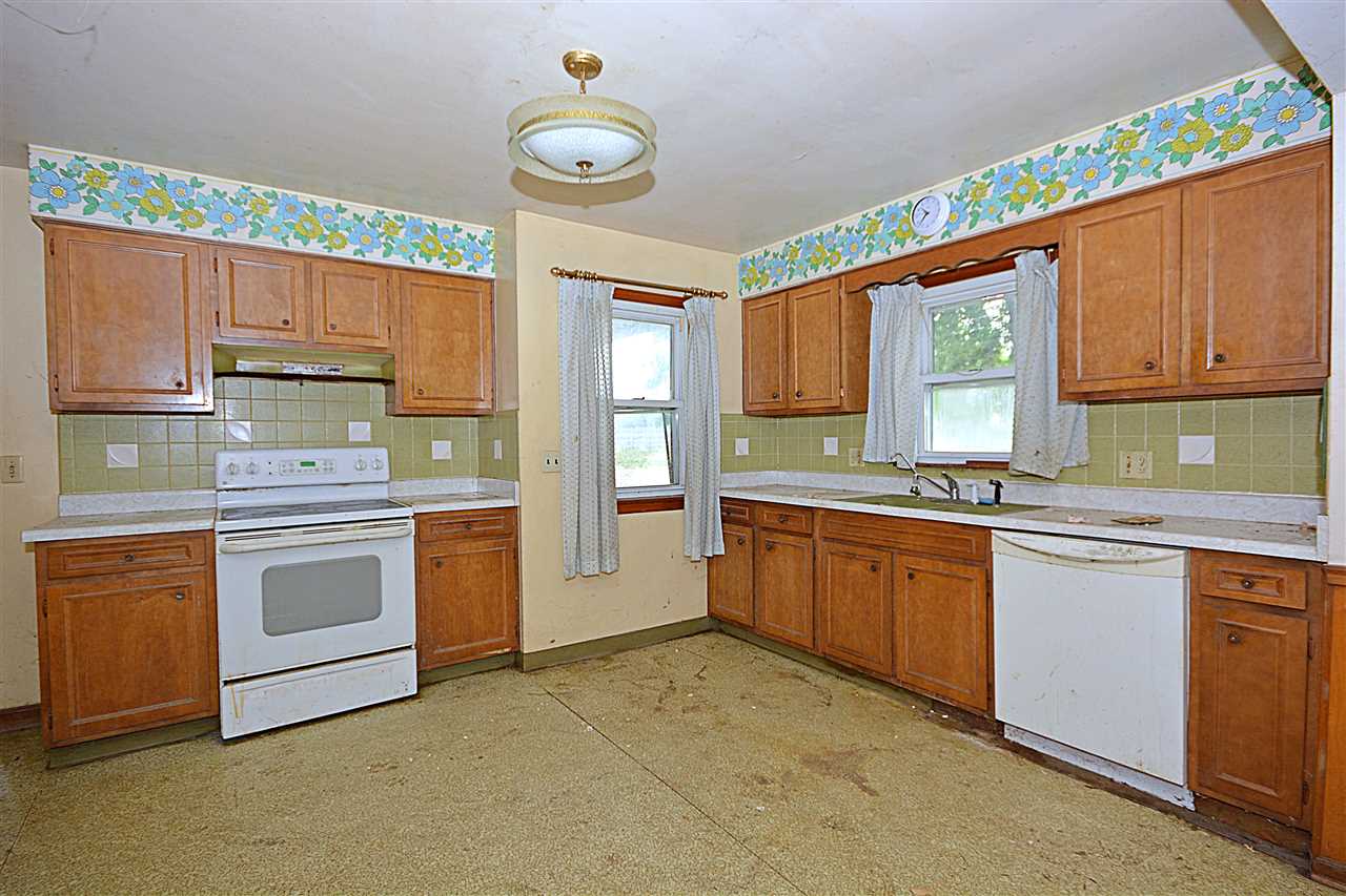 916 Windsor Road Loves Park, IL 61111 - Photo 8 of 14 a kitchen with granite countertop a stove sink and cabinets