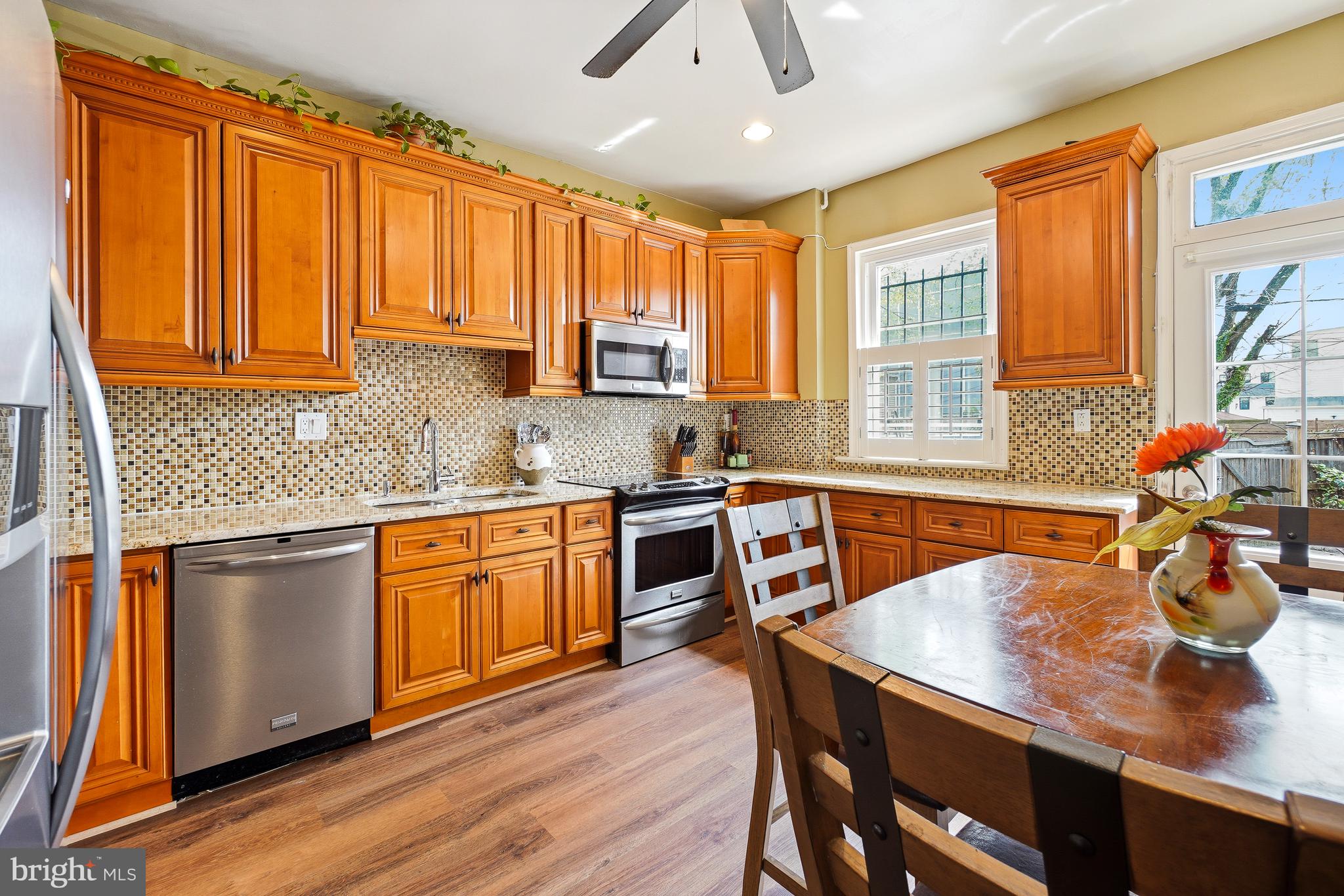 323 W Street Northeast Washington, DC 20002 - Photo 6 of 22 a kitchen with stainless steel appliances granite countertop sink stove top oven and cabinets