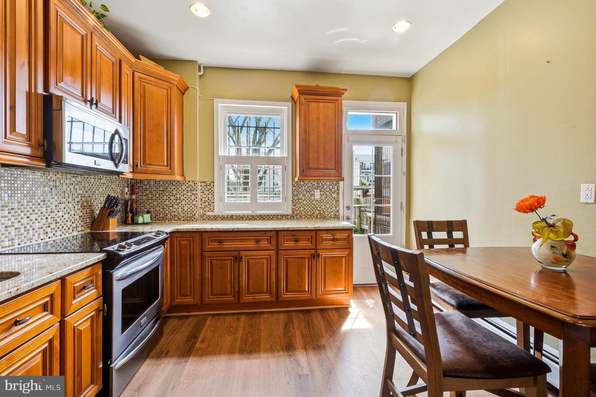 323 W Street Northeast Washington, DC 20002 - Photo 9 of 22 a kitchen with stainless steel appliances granite countertop a stove a sink dishwasher and a refrigerator with wooden cabinets