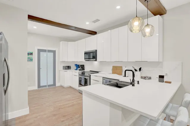 a kitchen with a sink a stove and refrigerator