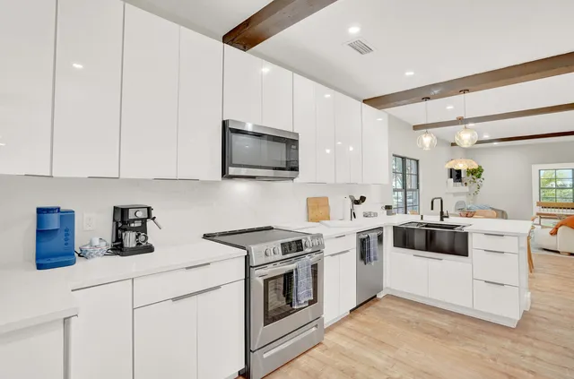 a kitchen with a sink stove and microwave
