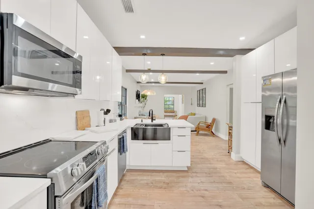 a kitchen with a stove a refrigerator and a sink