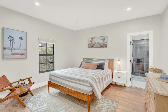 a bedroom with a bed a table and chair