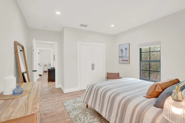 a bedroom with a large bed and a large window