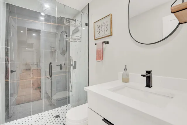 a bathroom with a sink toilet and shower