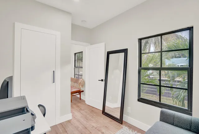 a view of a livingroom with furniture and hardwood floor