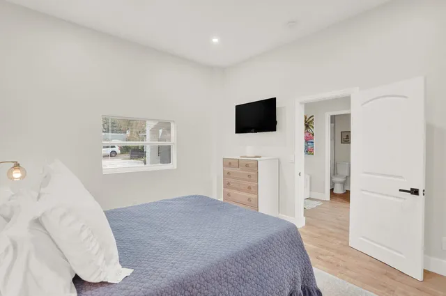 a bedroom with a bed and a flat screen tv