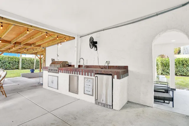 a kitchen with a sink and a stove top oven