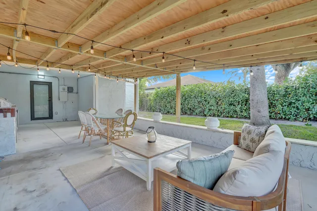a view of a porch with furniture and garden
