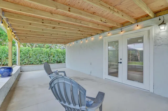 a view of a patio with chairs and a table