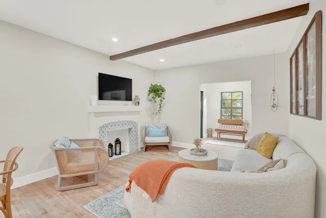 a living room with fireplace furniture and a flat screen tv