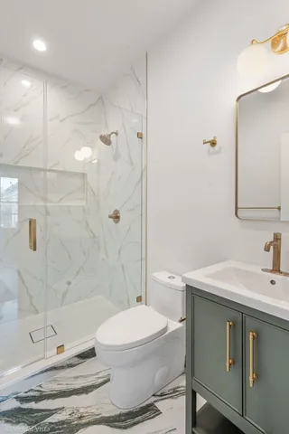 a bathroom with a sink toilet and shower