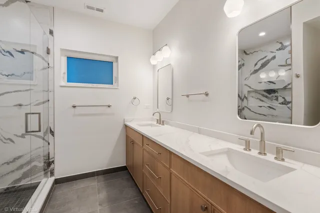 a bathroom with a double vanity sink mirror and