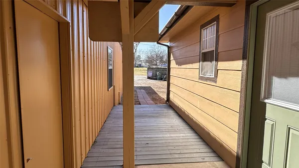 a view of a balcony with wooden floor