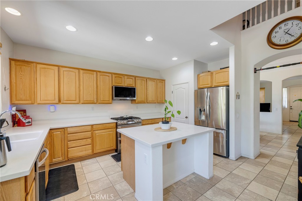 3819 St Austell Way Perris, CA 92571 - Photo 13 of 64 a kitchen with a sink appliances and cabinets