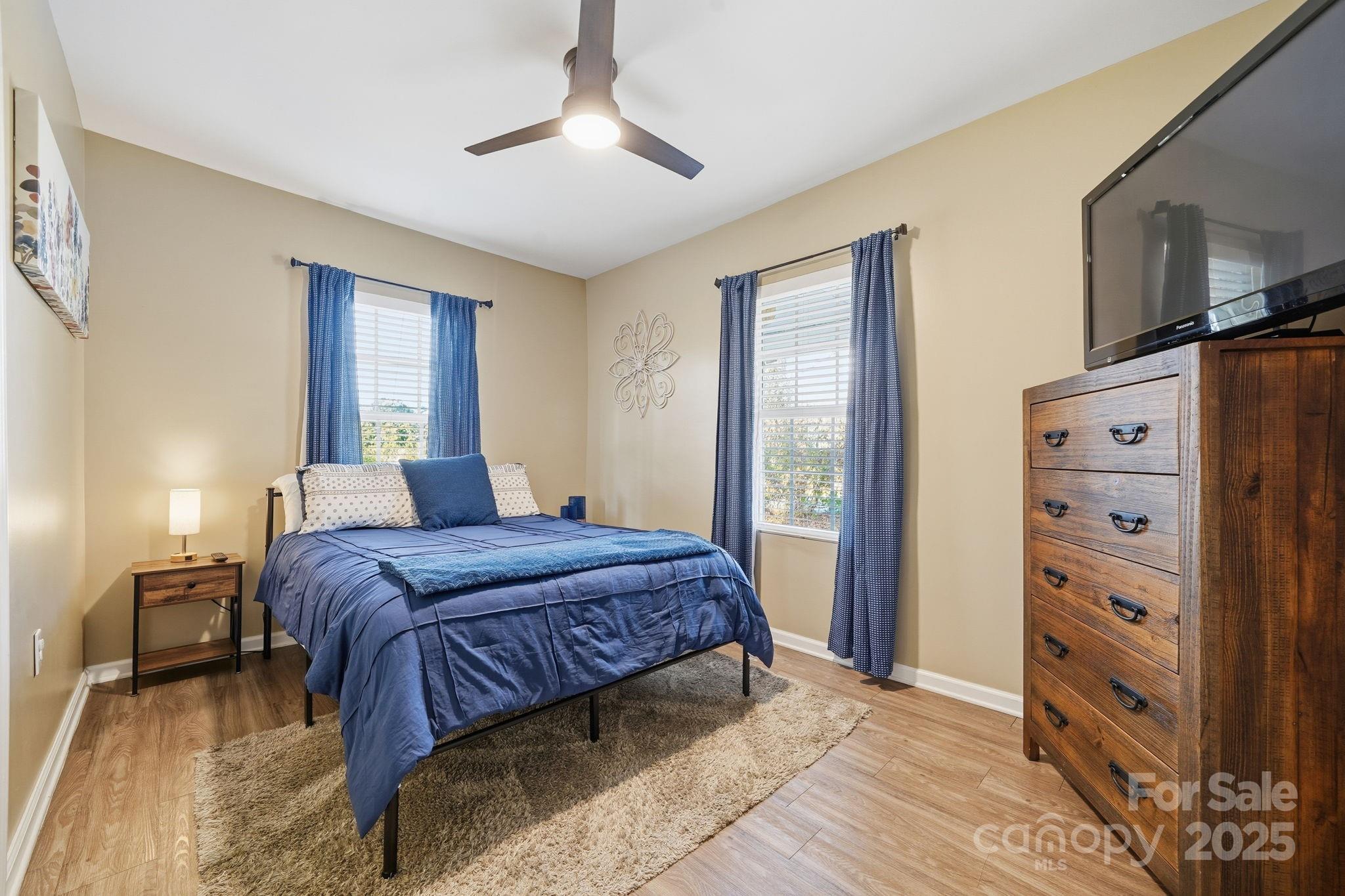 2301 Acme Road Belmont, NC 28012 - Photo 16 of 25 a bedroom with a bed and a chandelier