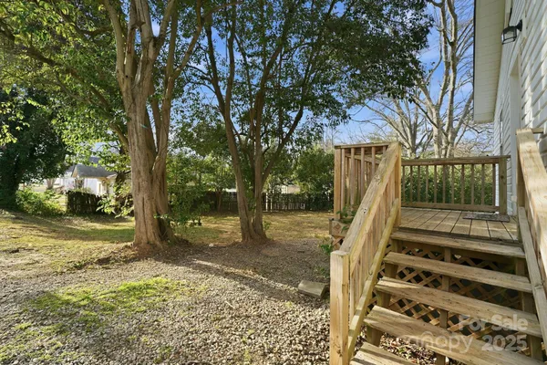 a view of balcony with wooden floor and fence