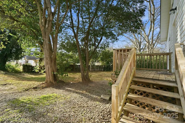 a view of balcony with wooden floor and fence
