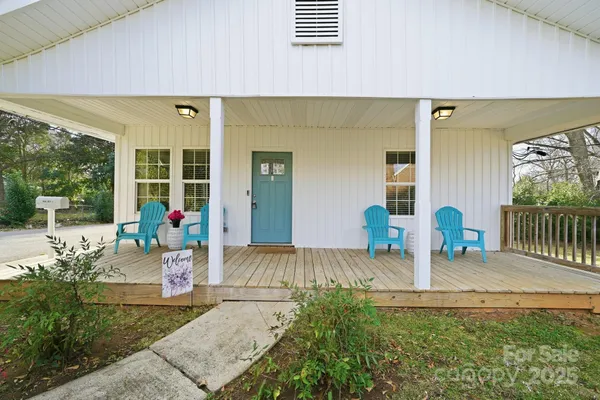 a view of a deck with table and chairs and wooden floor