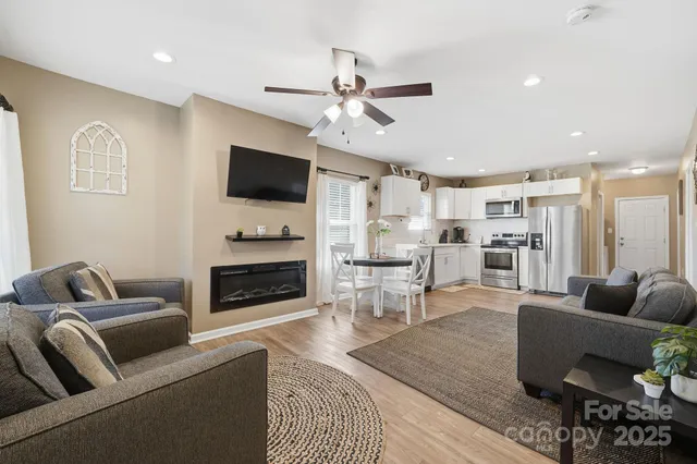 a living room with furniture and kitchen view