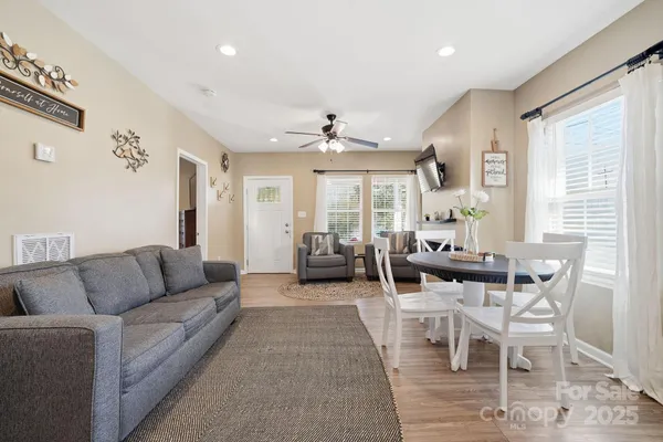 a living room with furniture and wooden floor