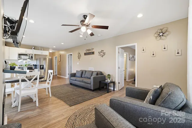 a living room with furniture and a wooden floor