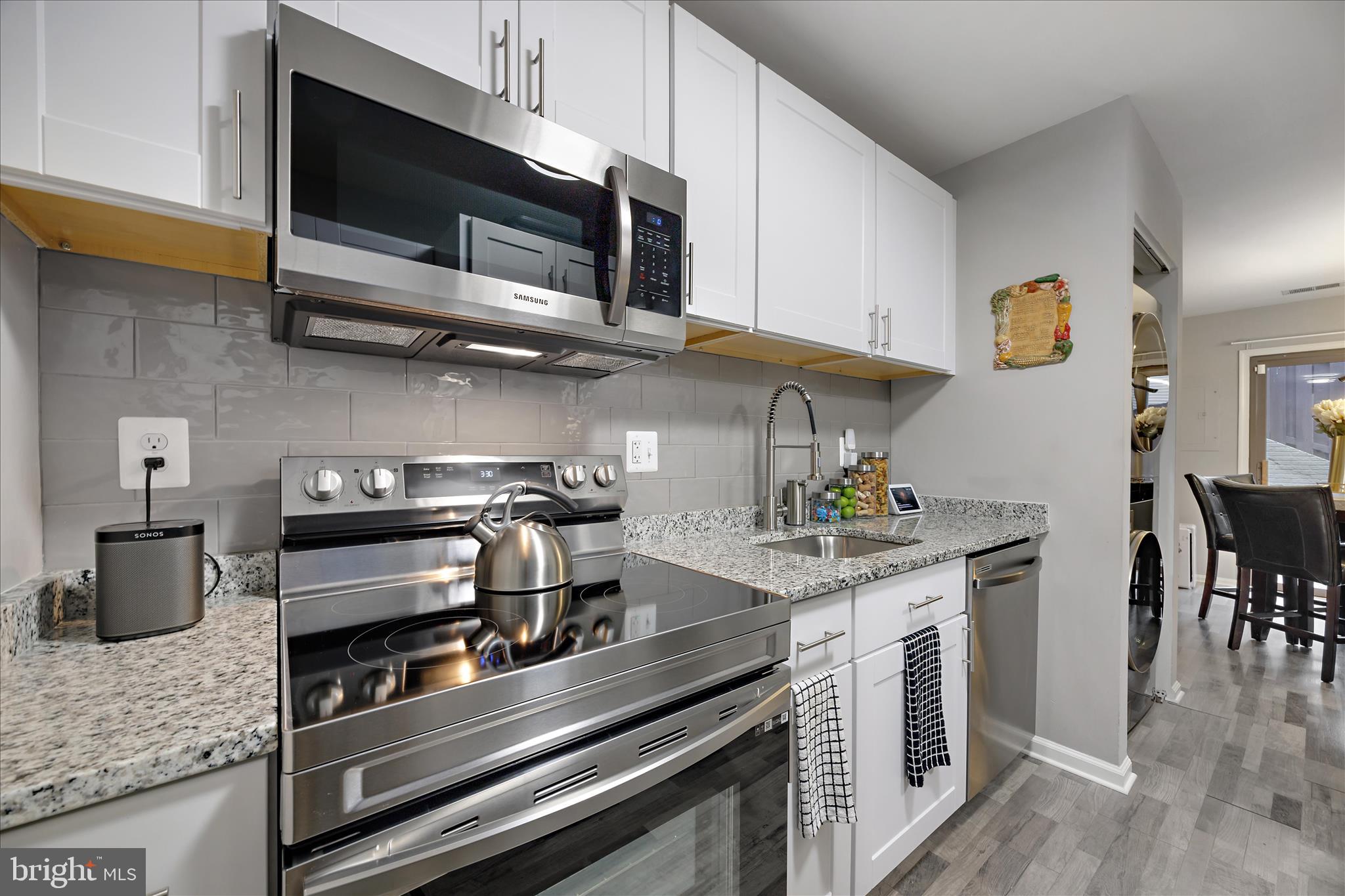 7314 Split Rail Lane Laurel, MD 20707 - Photo 18 of 32 a kitchen with stainless steel appliances granite countertop a stove and a microwave