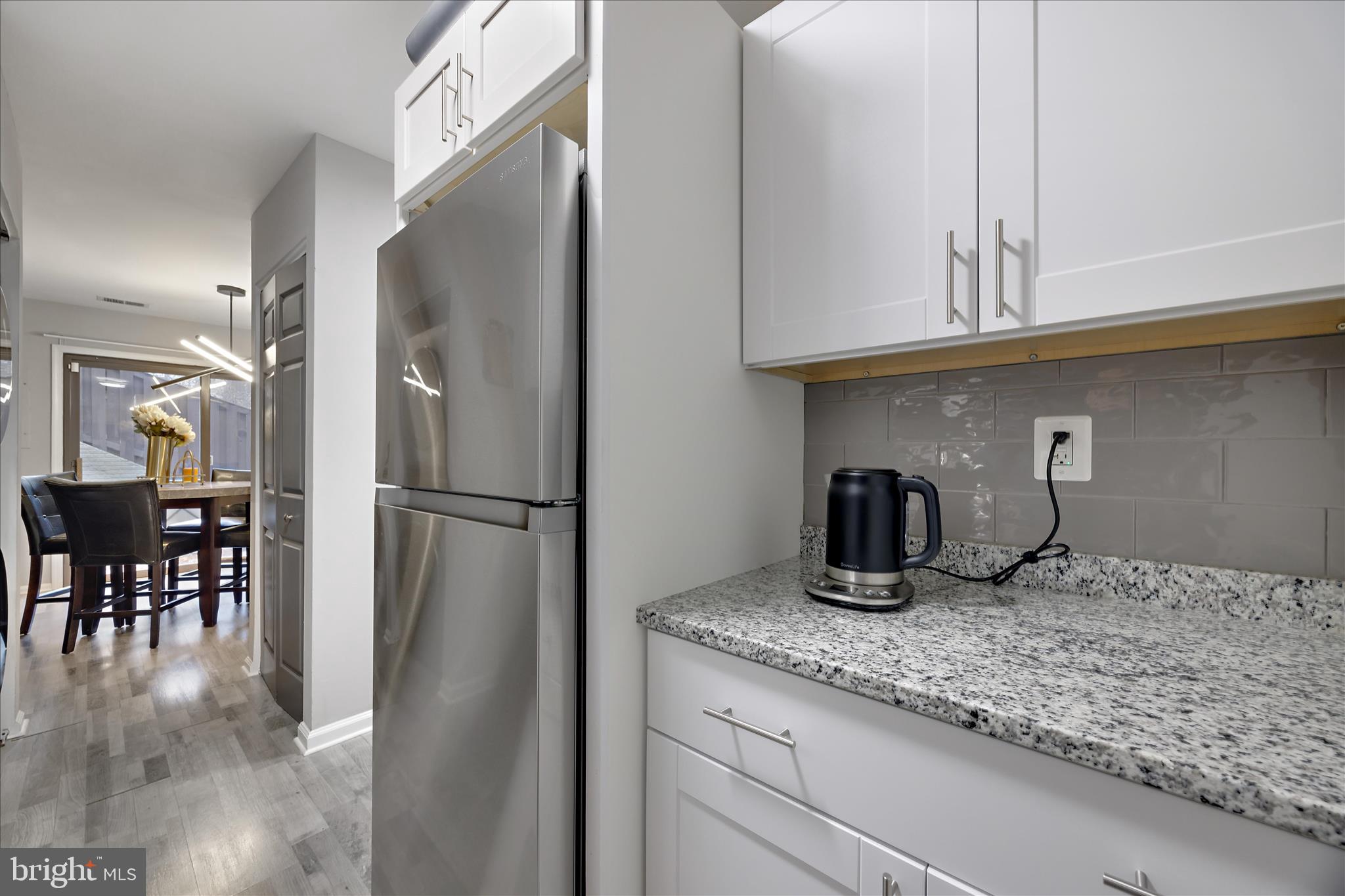 7314 Split Rail Lane Laurel, MD 20707 - Photo 19 of 32 a kitchen with granite countertop stainless steel appliances a sink and refrigerator