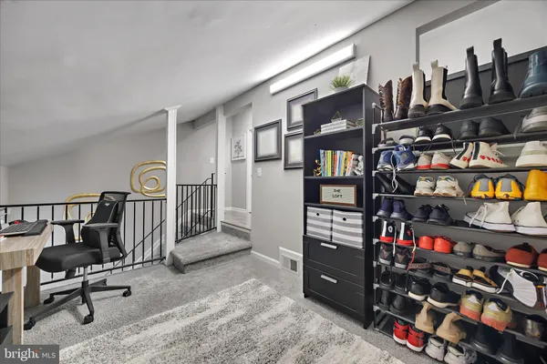a room with lots of books and chairs