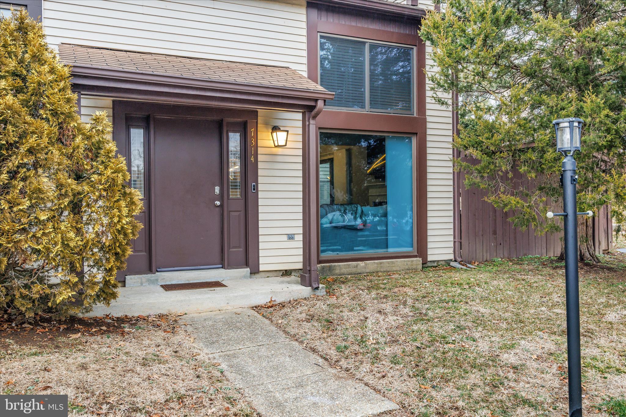 7314 Split Rail Lane Laurel, MD 20707 - Photo 3 of 32 a view of yellow house with a large window and yard