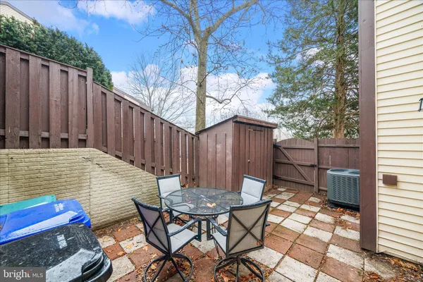 a backyard of a house with table and chairs