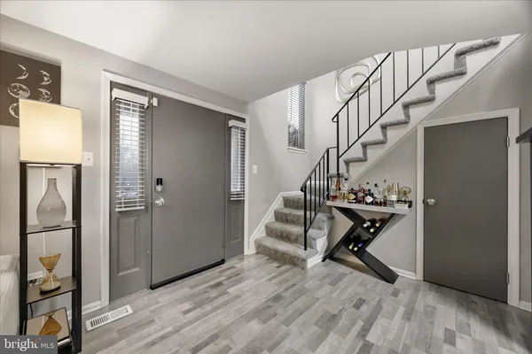 a view of entryway with wooden floor and stairs